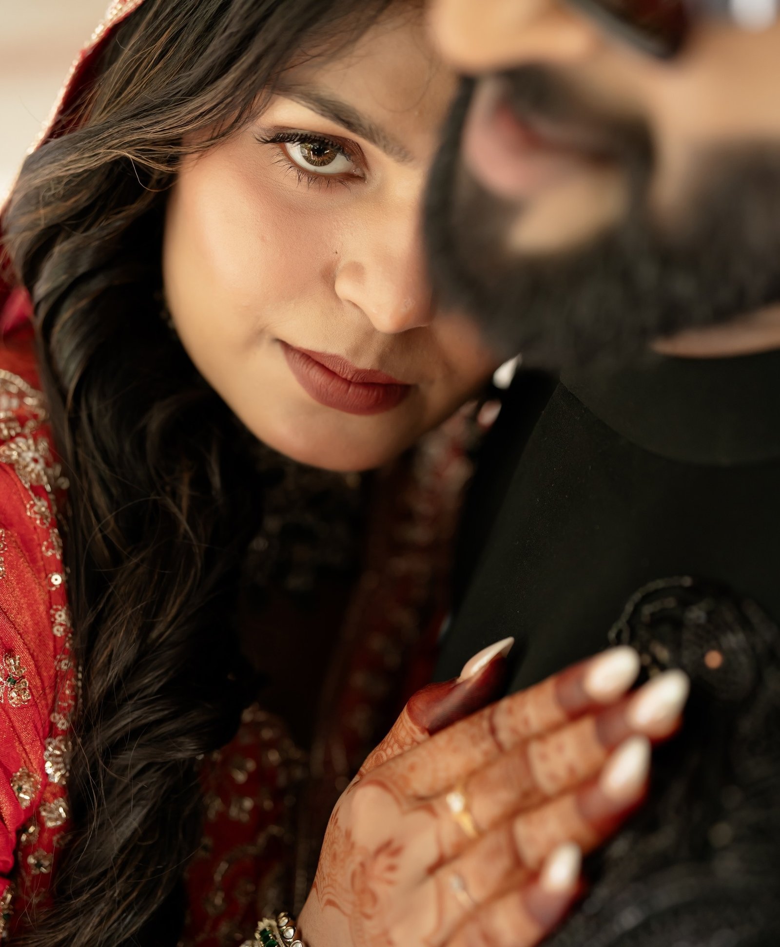 A close bridal portrait with henna and wedding jewellery